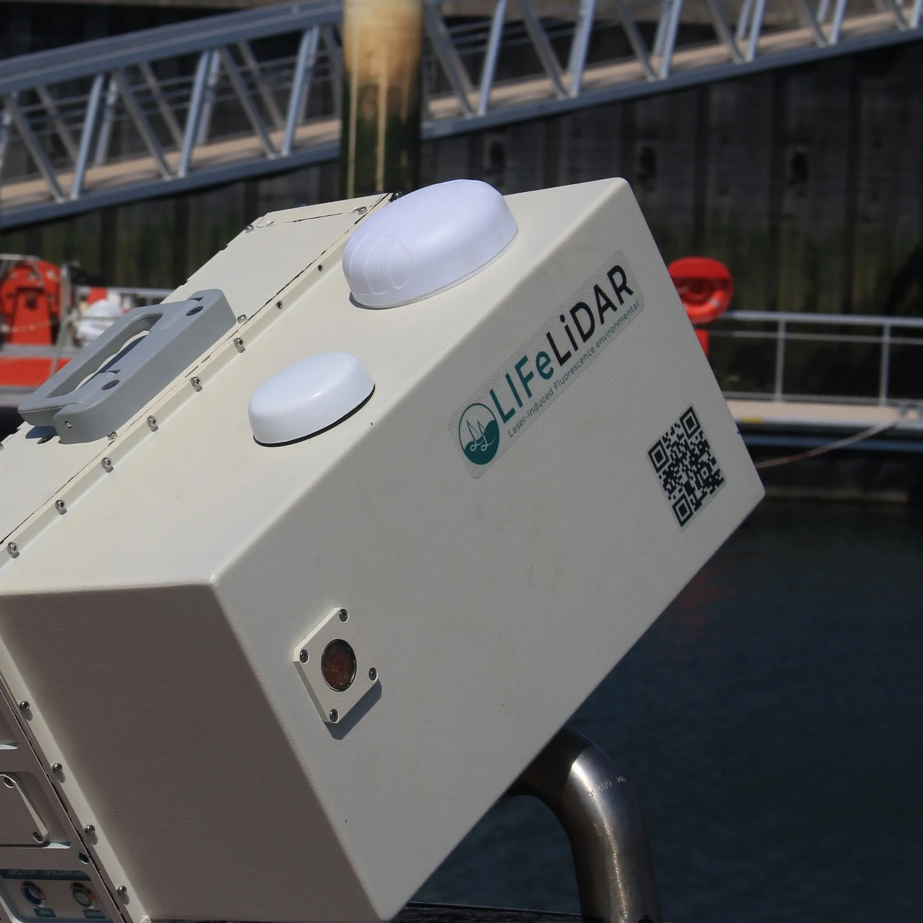 LIFL-11 rail-mounted in harbour, a rescue vessel moored behind
