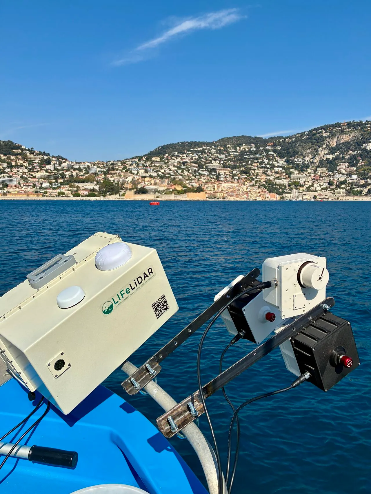 The LIFL-11 and a second instrument mounted on the rail of a survey vessel, the town of Villefranche-sur-Mer on the hillside behind